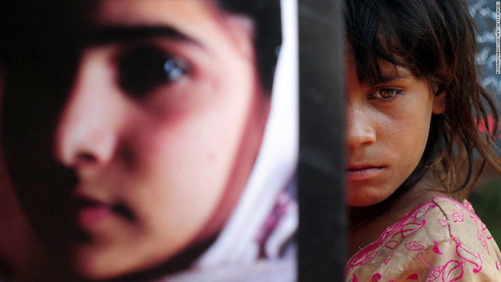 A Pakistani girl carries a photograph of Malala in Karachi to mark Malala Day.