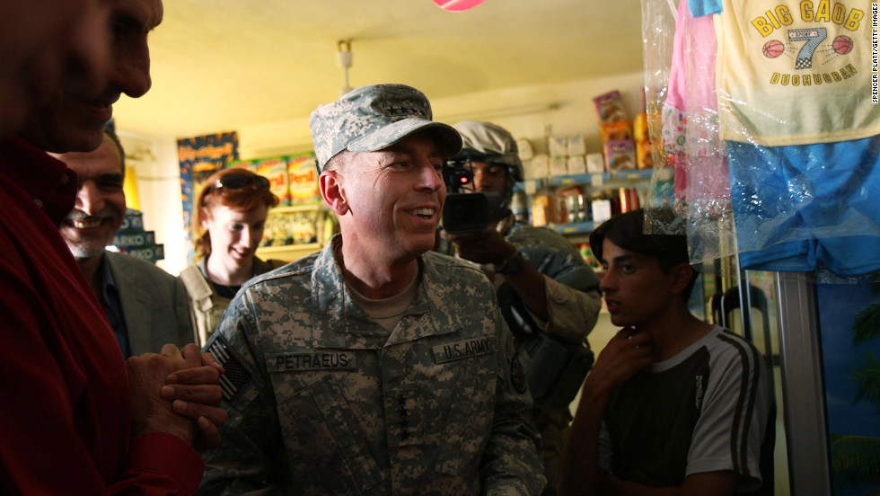Petraeus speaks with store owners in the Ghazaliya neighborhood in Baghdad in August 2007.
