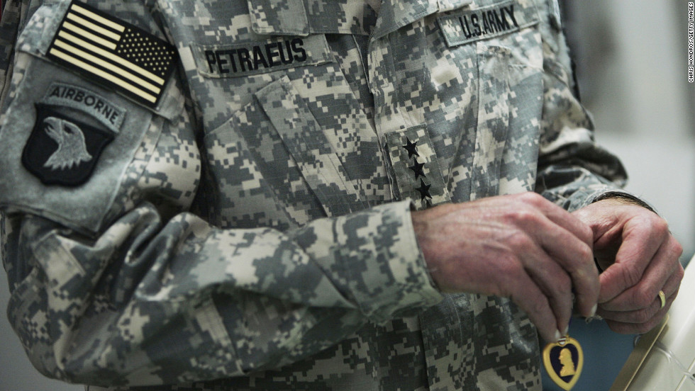 Gen. David Petraeus was promoted to commander of all U.S. forces in Iraq in February 2007. Pictured, Petraeus awards Purple Hearts to a wounded soldiers at the 28th Combat Support Hospital in March 2007 in Baghdad, Iraq. 