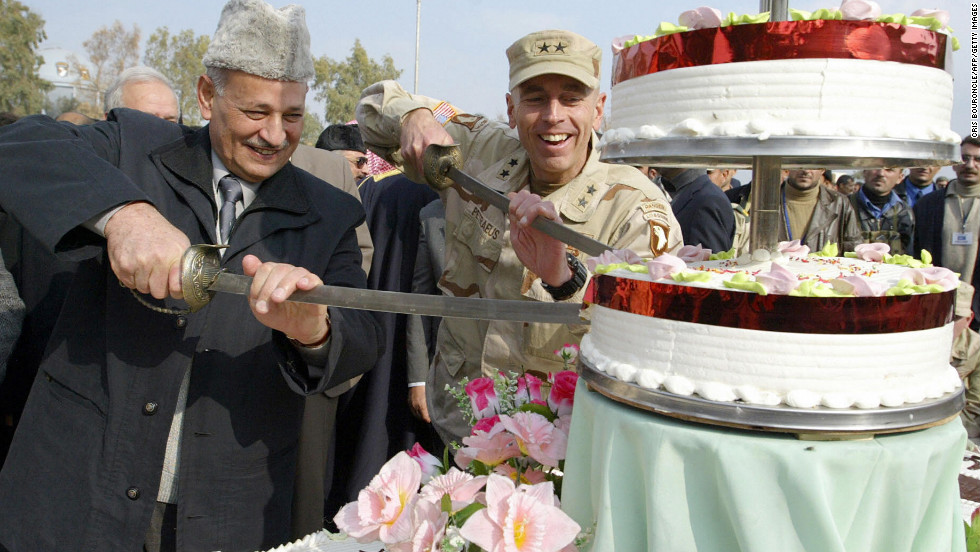 Provincial Governor Ghanem al-Basso, left, commemorates the 83rd anniversary of the establishment of the Iraqi army with Petraeus and the graduation of its new 2nd Battalion in Mosul, Iraq.  