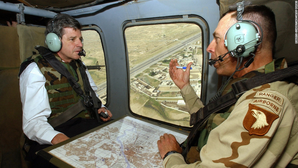 Petraeus served as commanding general of the 101st Airborne Division U.S. Army between 2002 and 2004 and led troops into battle  when the U.S. invaded Iraq in March 2003. Pictured, Petraeus speaks with  Paul Bremer, the new U.S. overseer in Iraq, during a helicopter tour of Mosul, Iraq, in May 2003.