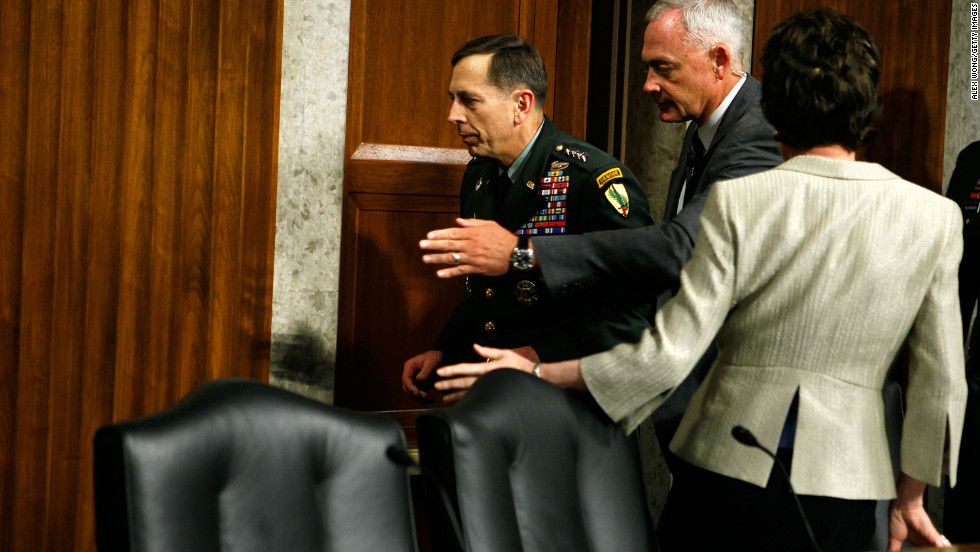 Petraeus apparently faints while testifying during a hearing before the Senate Armed Services Committee in June 2010 in Washington. Pictured, he is escorted away after the incident.