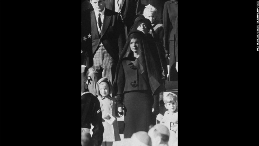 On November 22, 1963, President John F. Kennedy was assassinated while in a presidential motorcade in Dallas. Pictured, Kennedy&#39;s widow, Jacqueline Kennedy, children, Caroline and John, and mother, Rose Kennedy, behind, wait outside St. Matthew&#39;s Cathedral for the procession to the cemetery during his funeral on November 25. 