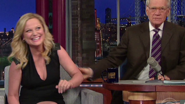 Letterman plants kiss on Amy Poehler. 