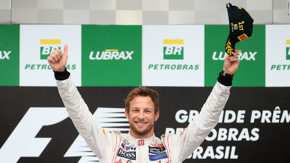 Button salutes the crowd at Interlagos following his victory. He said: &quot;First of all I want to congratulate the whole team. This is  the perfect way to end the season. We have had ups and downs and to end on a  high bodes well for 2013.&quot;
