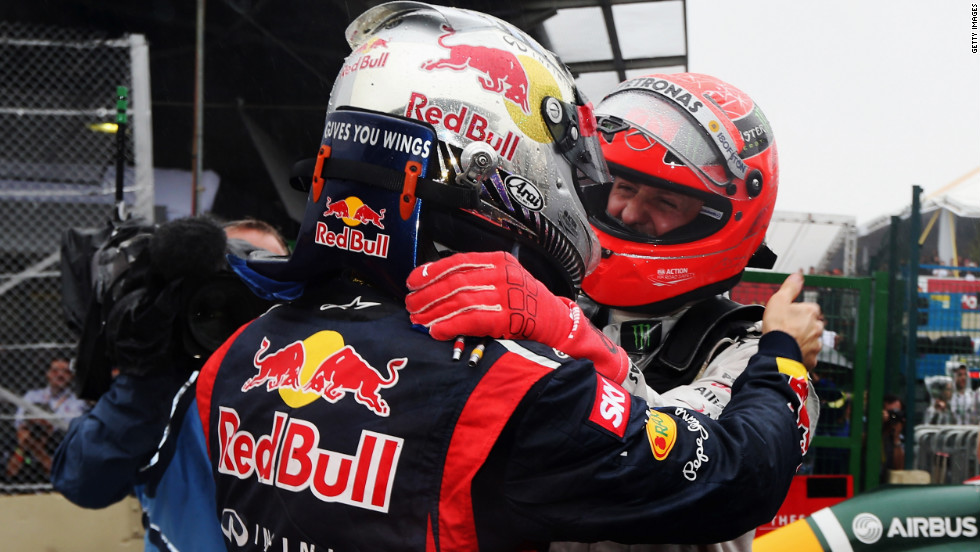Michael Schumacher congratulates fellow German Vettel on his title triumph. Seven-time world champion Schumacher finished seventh in his final race before retirement. 