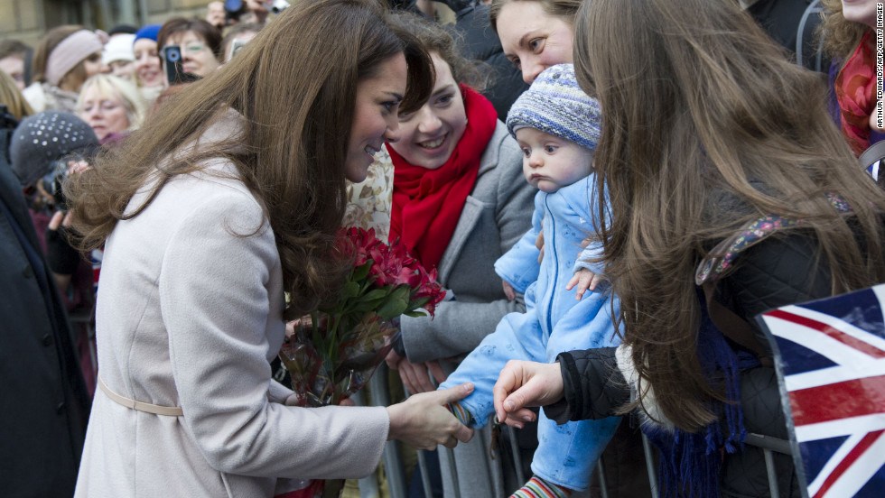 Catherine, Duchess of Cambridge, left, meets 5-month-old James William Davies as she arrives at the Guildhall during her visit to Cambridge on November 28, 2012. Prince William and his wife, Catherine, are expecting their first child, the palace announced Monday, December 3. Click through this gallery to see the her interacting with the younger generation.