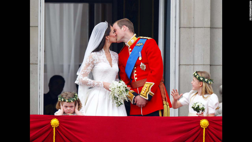 Prince William and Kate kiss on the balcony of Buckingham Palace in London after their wedding at Westminster Abbey on April 29, 2011. Two young bridesmaids, Grace Van Cutsem, left, and Margarita Armstrong-Jones, right, seem to have differing views of being in the public eye.