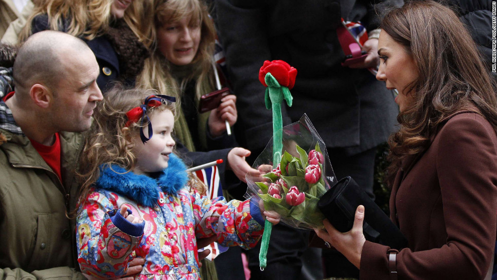 A young girl offers Catherine a toy rose as the Duchess visits Alder Hey Children&#39;s Hospital on February 14, 2012, in Liverpool, England. Interacting with children during visits to hospital or charities is a part of official duties that Catherine seems to enjoy.