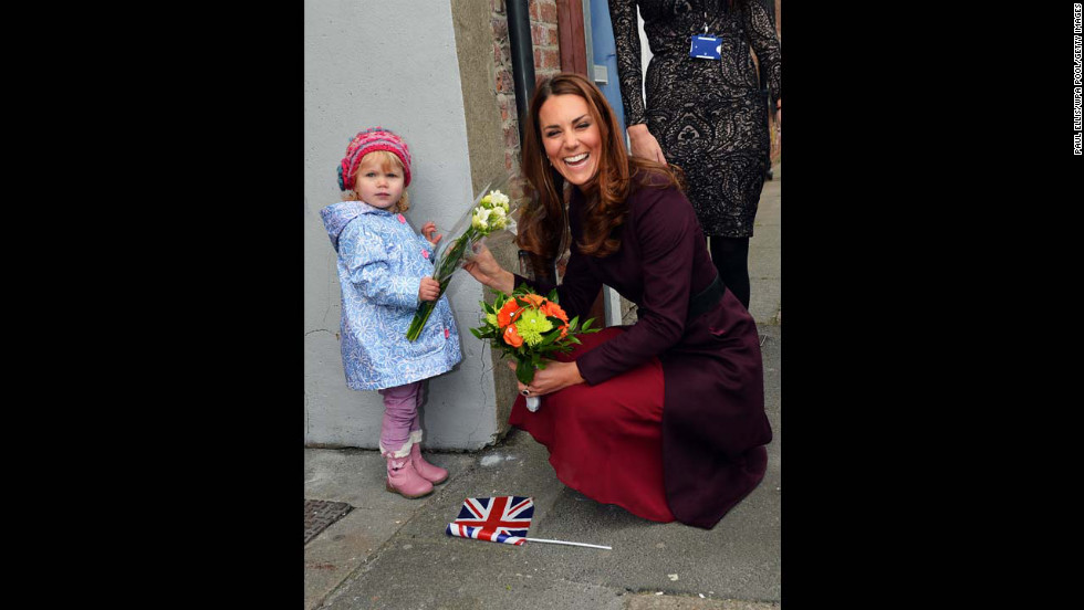 Catherine laughs as she receives flowers from 2-year-old Lola Mackay, who refused to let go of them, during a visit to the CRI Stockton Recovery Service on October 10, 2012, in Stockton-on-Tees, England.  