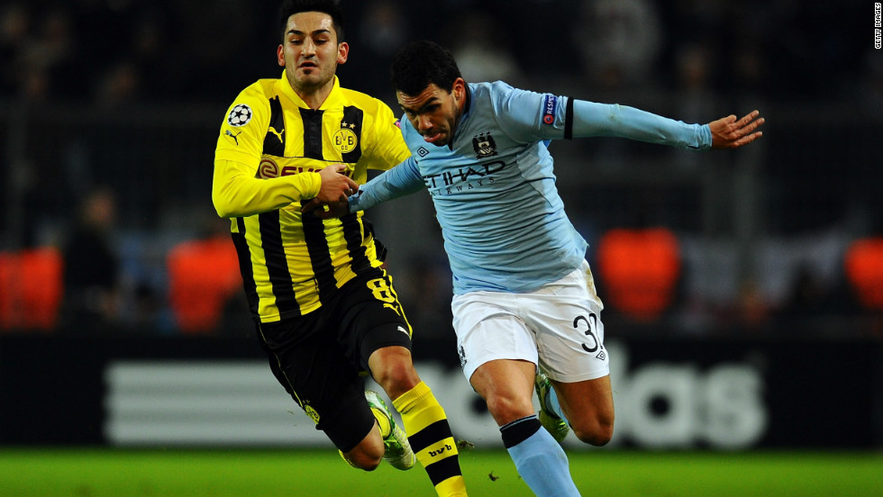 Carlos Tevez takes on Ilkay Guendogan of Borussia Dortmund during a frustrating night for Manchester City as it crashed out of European competition with a 1-0 defeat. City becomes the first English team to have failed to win a single group game in the compeititon.