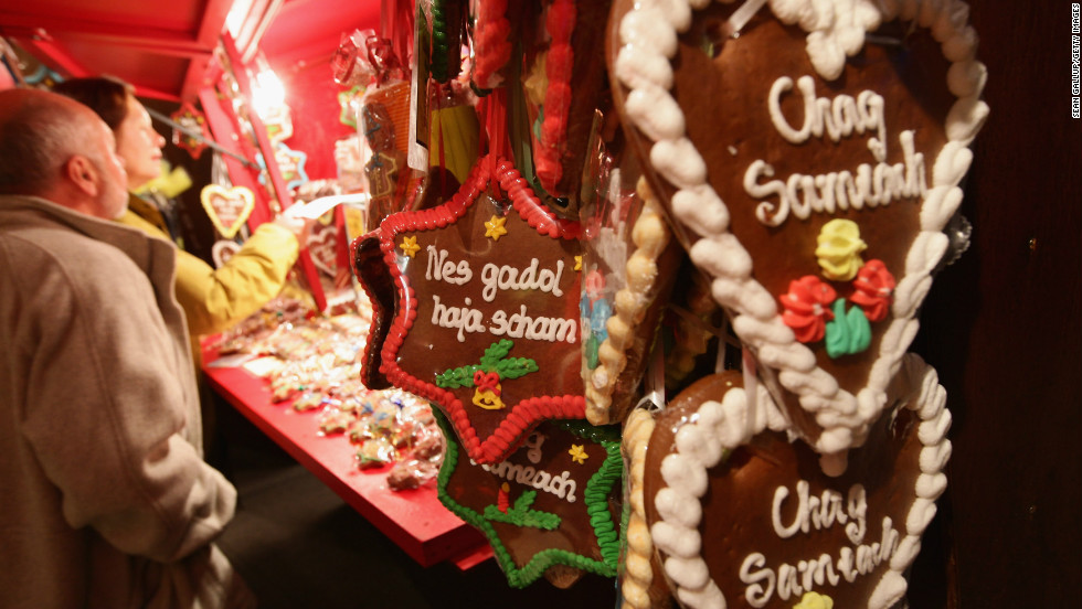 Jewish bakers are busy with more than just doughnuts and latkes during this time of year. Here, traditional gingerbread hearts and Stars of David with Hebrew inscriptions in Latin letters on them hang at a stall at the annual Hanukkah market at the Berlin Jewish Museum. 