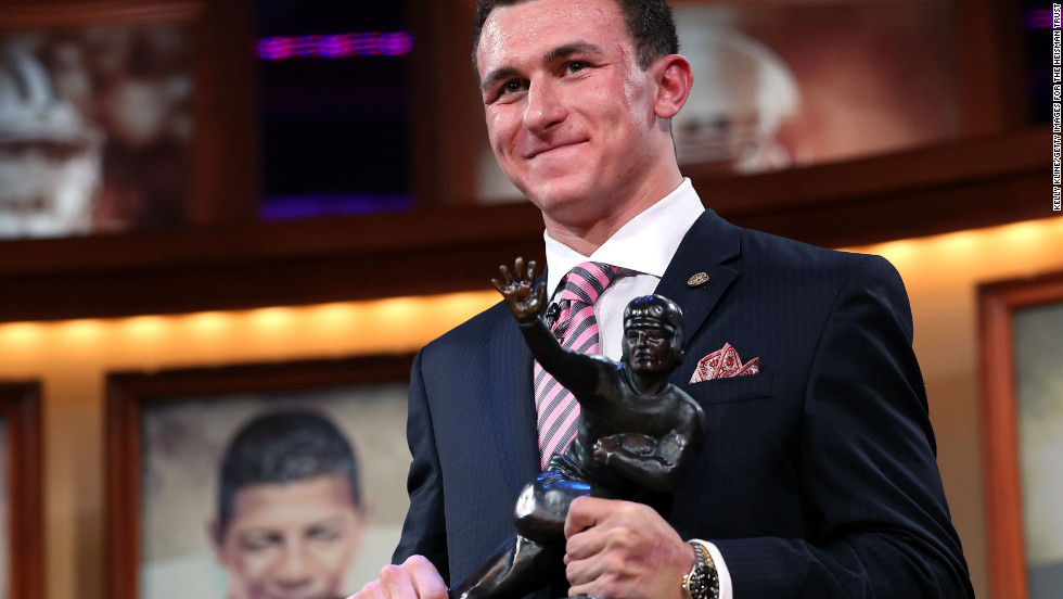 Quarterback Johnny Manziel of the Texas A&amp;amp;M University Aggies poses with the Heisman Memorial Trophy after being named the 78th Heisman Memorial Trophy Award winner at the Best Buy Theater on December 8 in New York City.