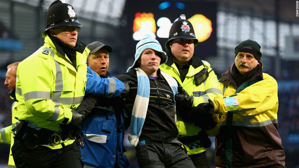 Police intervened to eject the invader, and the Greater Manchester force also announced after the match that another man was arrested inside City&#39;s Etihad Stadium on suspicion of chanting racist abuse.