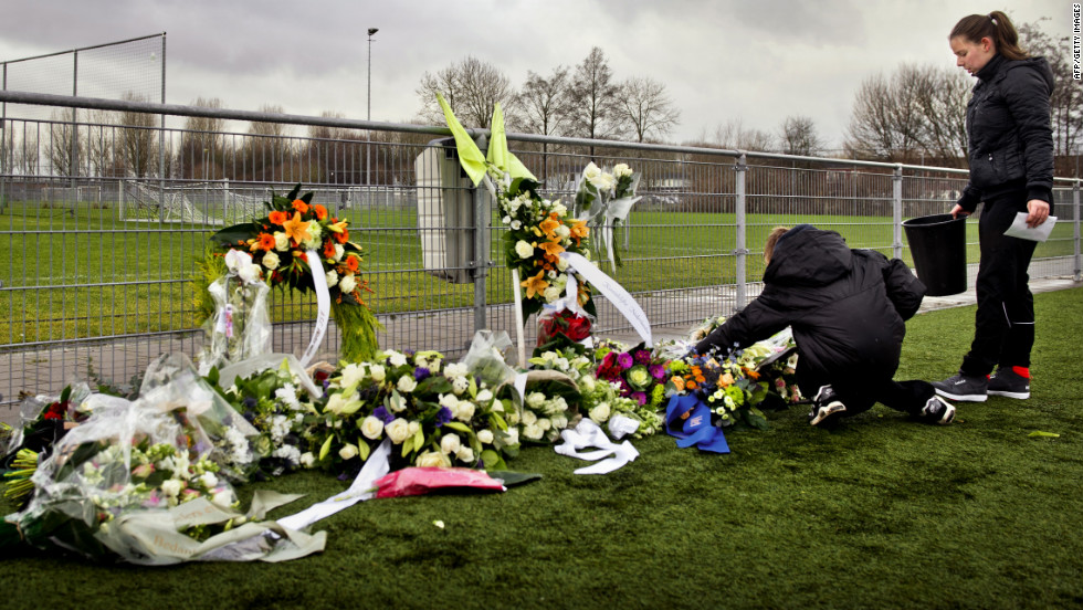 People lay flowers for Nieuwenhuizen at the Buitenboys clubhouse in Almere on December 9, 2012. Eight people have been arrested in connection with the attack, which came following a match against Amsterdam&#39;s Nieuw  Sloten.