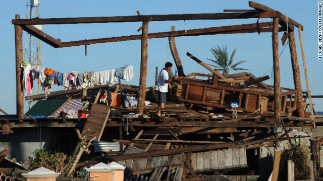 A resident stands on his destroyed house in Cateel town on December 11.