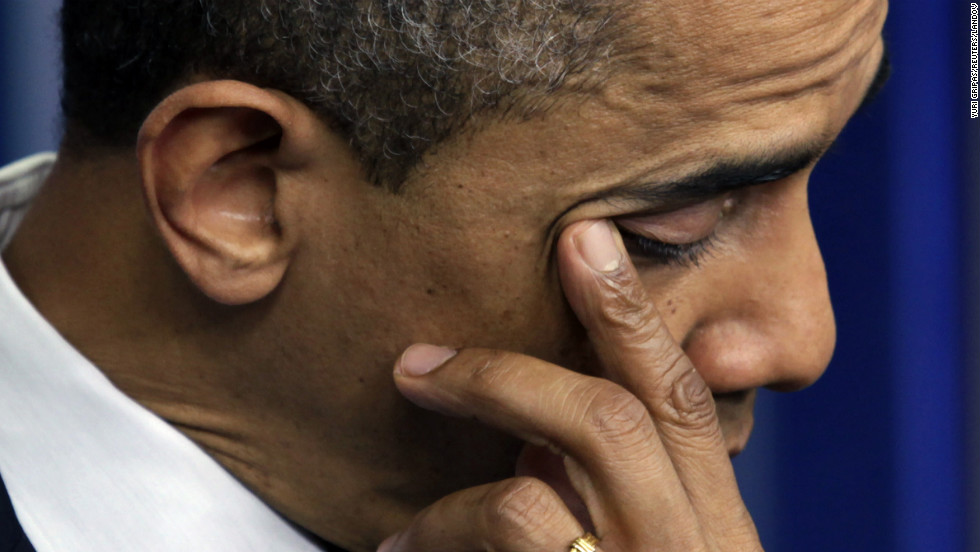 President Barack Obama wipes a tear as he speaks about the shooting at Sandy Hook Elementary School during a press briefing at the White House on December 14.