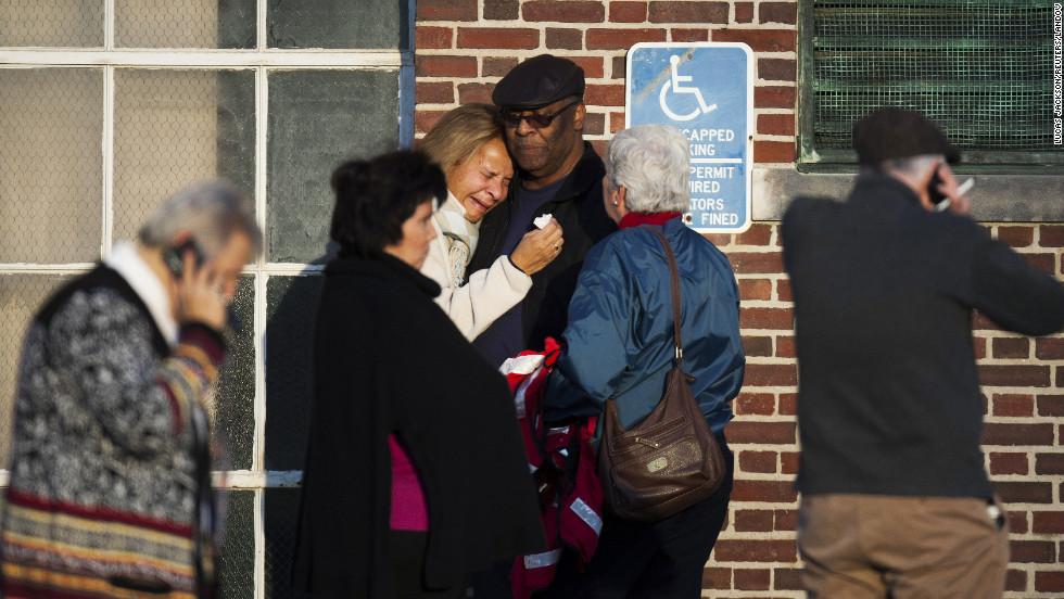 A woman leans on a man as she weeps near Sandy Hook Elementary School on December 14.