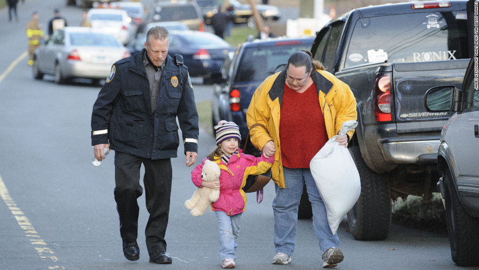 A child and her mother leave a staging area outside Sandy Hook Elementary School in Newtown, Connecticut, on December 14. 