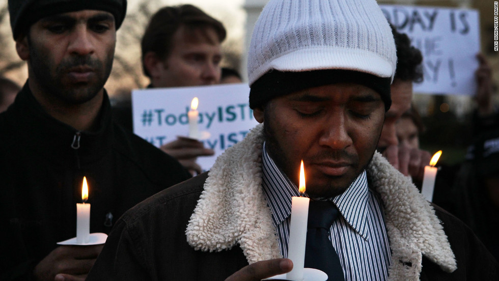 Faisal Ali, right, of Colorado Springs, Colorado, joins the vigil outside the White House.