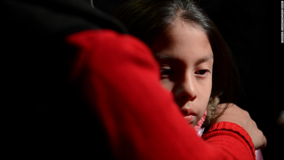 Cynthia Alvarez is comforted by her mother, Lilia, as people gather for a prayer vigil at St. Rose of Lima Roman Catholic Church  in Newtown.