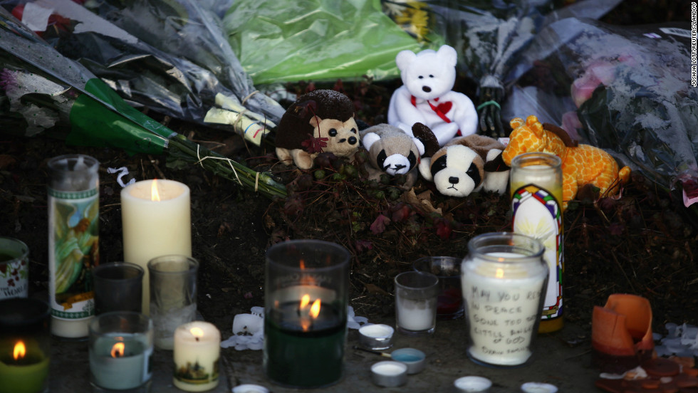 A makeshift memorial with flowers, stuffed toys and candles sit outside Saint Rose of Lima Roman Catholic Church in Newtown, Connecticut, on Saturday.
