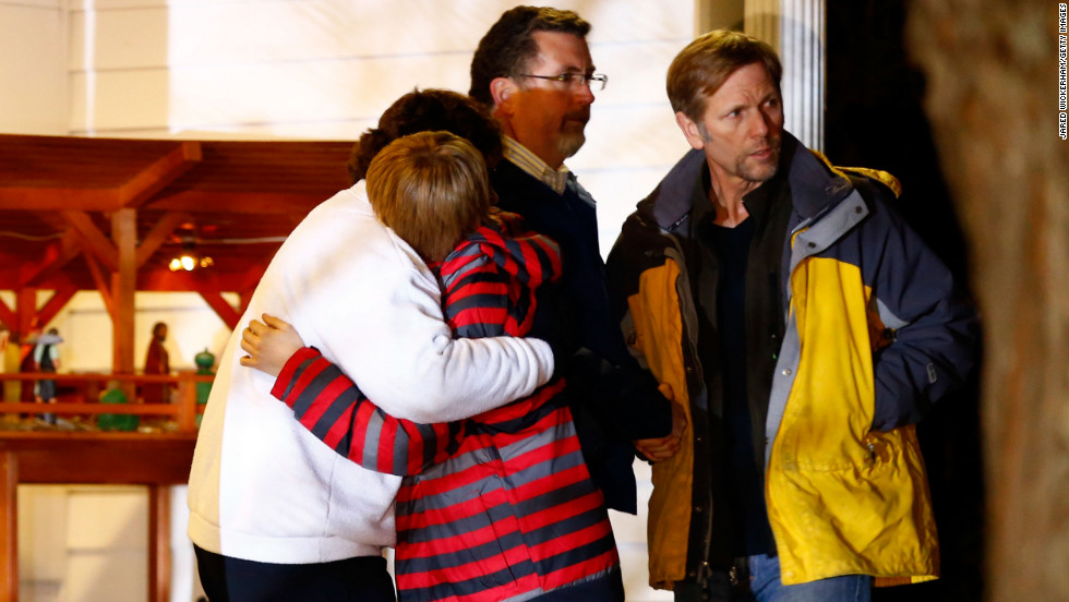 People hug outside of the Newtown United Methodist Church on Friday, near the site of the shootings at the Sandy Hook school.