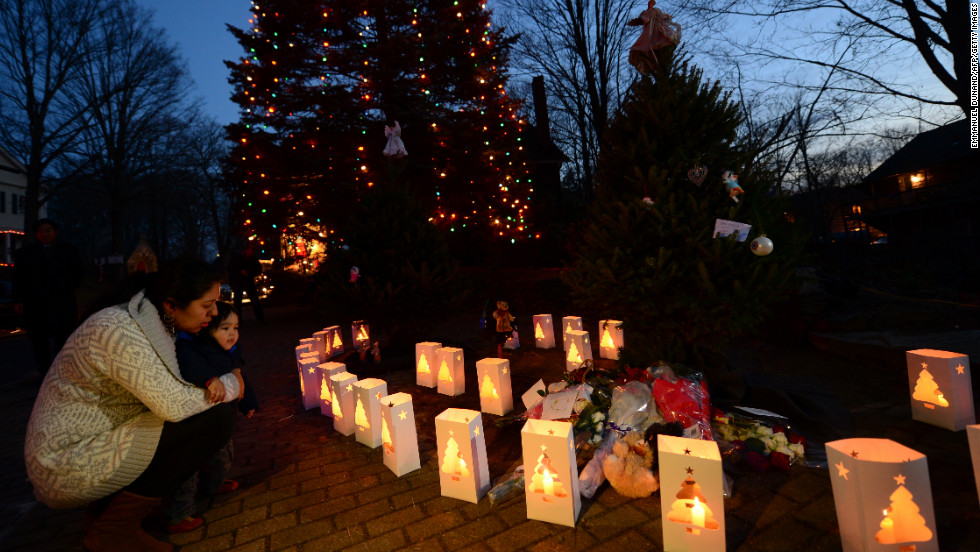 Candles burn next to a lighted tree at a makeshift shrine in Newtown, Connecticut, commemorating the victims of the mass shooting at Sandy Hook Elementary School on December 14, 2012.