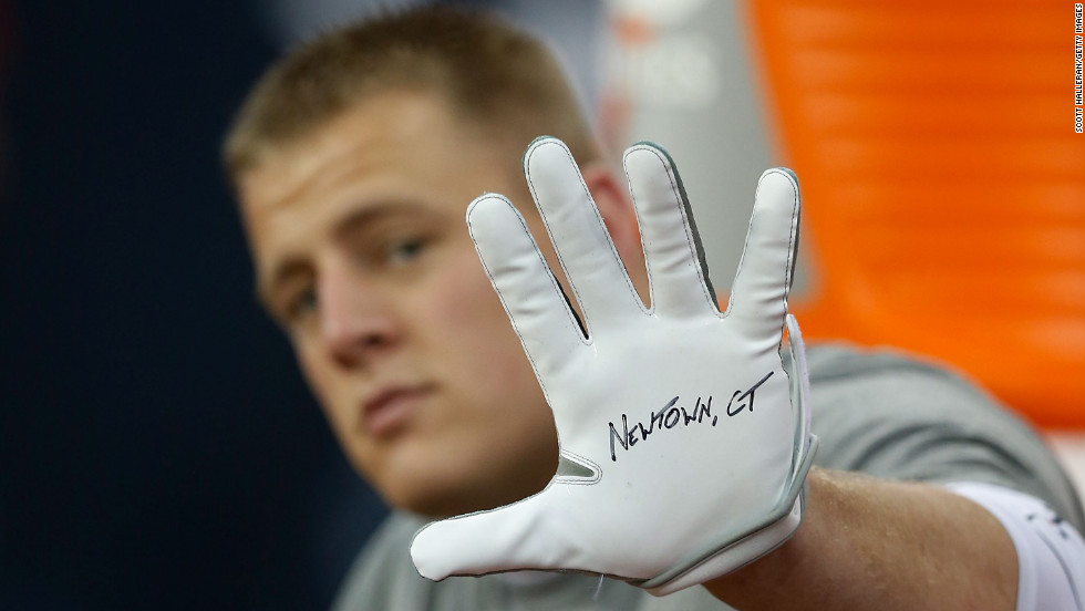 J.J. Watt of the Houston Texans shows his glove in remembrance of the victims before the start of a game against the Indianapolis Colts on December 16 in Houston. 
