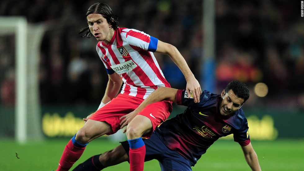 Barcelona&#39;s forward Pedro Rodriguez and Atletico&#39;s Filipe Luis go in for a challenge as La Liga&#39;s top two went head-to-head. Barca had taken an incredible 43 points from a possible 45, winning 14 of their 15 league games to lead Atletico by six points.