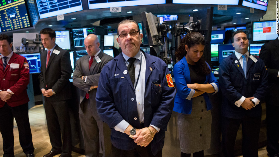 Traders on the floor of the New York Stock Exchange hold a moment of silence on December 17 in honor of the shooting victims.