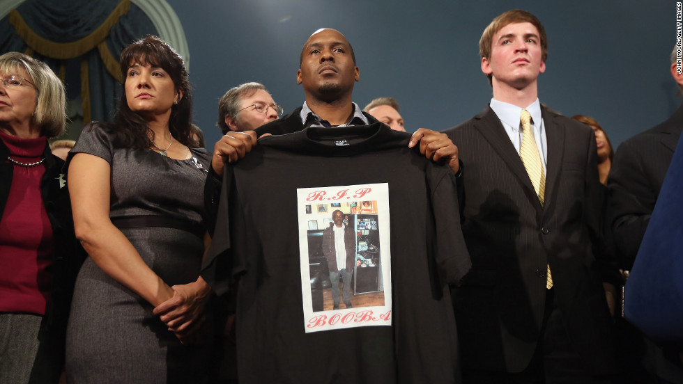 Chris Foye, whose son Chris Owens was killed by a stray bullet in 2009, stands with other survivors and family members of gun violence at Bloomberg&#39;s press conference on December 17 in New York.