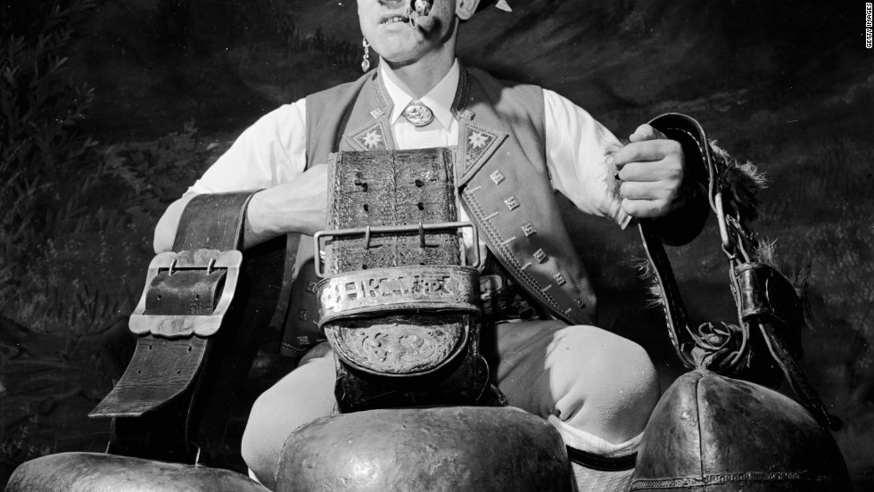 An Alpiner with three large cow bells, which produce that sombre rhythmic sound, at a traditional bell-swinging festival in 1955.