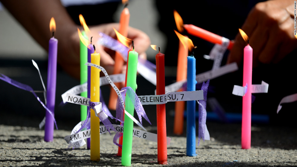 Members of the human rights group Volunteers Against Crime and Corruption light candles showing the names of those killed during the shooting at Sandy Hook Elementary School, during a prayer vigil in front of the U.S. Embassy in Manila, Philippines on December 18.