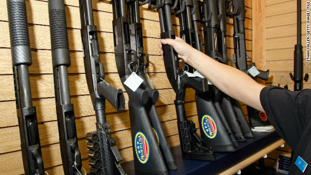 A sales associate takes a gun from a display of shotguns at The Gun Store November 14, 2008 in Las Vegas, Nevada. Store manager Cliff Wilson said he&#39;s seen a large spike in sales since Barack Obama was elected president on November 4, with customers citing fears about the president-elect&#39;s record on firearms.