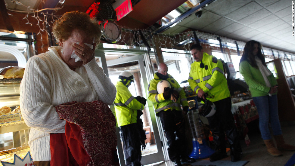 People observe a moment of silence for the school shooting victims at the Blue Colony Diner in Newtown on December 21.