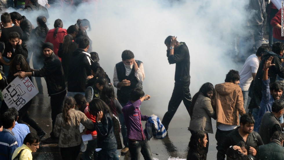Demonstrators react as police fire tear gas on December 22.