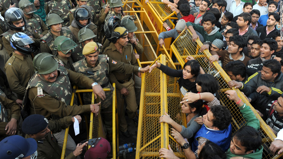 Demonstrators push against a police barricade on December 22.