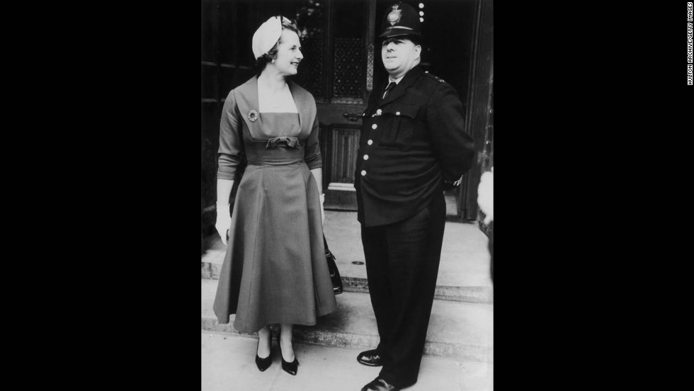 Thatcher chats with a police officer outside the House of Commons, where she took a seat as a member of Parliament for Finchley in October 1959. 