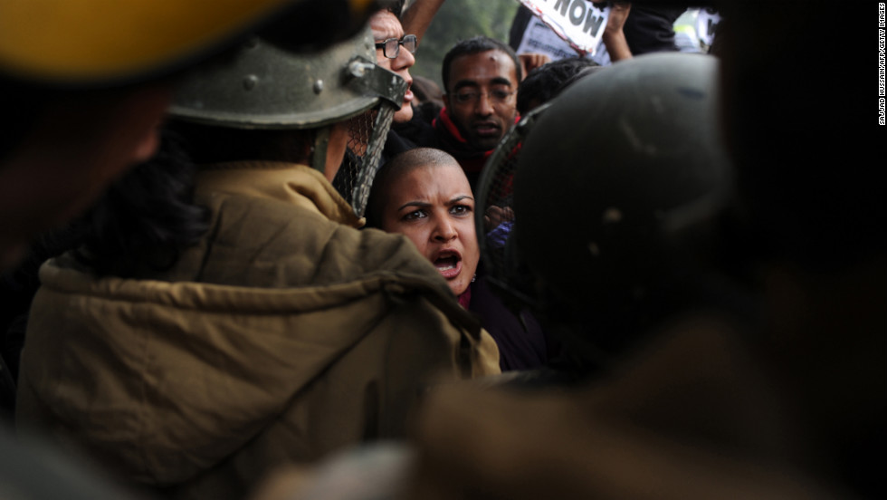 Demonstrators shout slogans and wave placards as they move toward India Gate in New Delhi on December 27.