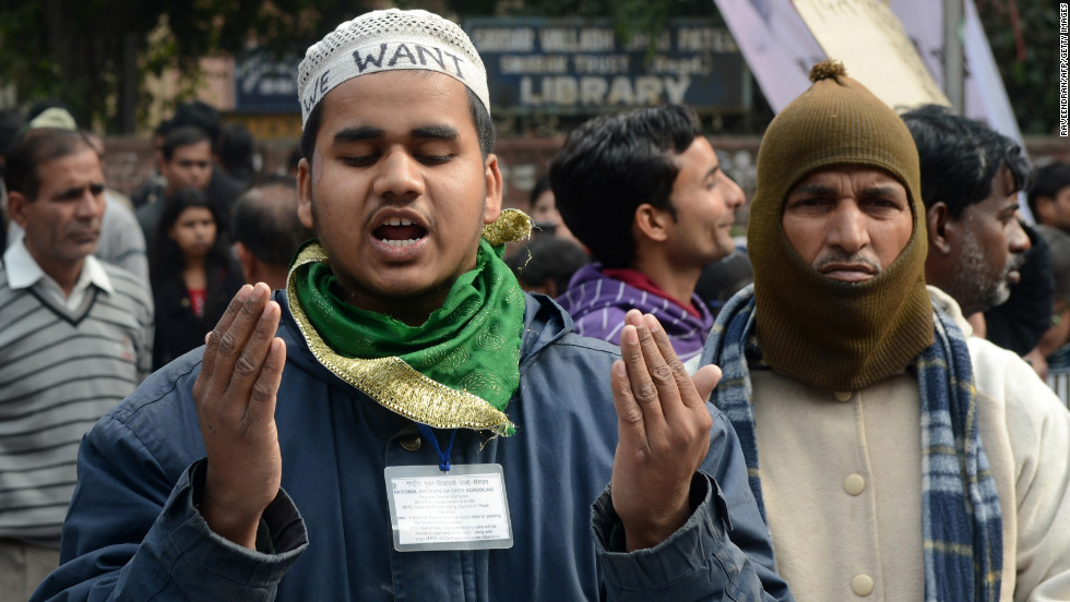 Indian residents pray during a gathering in New Delhi on December 30.