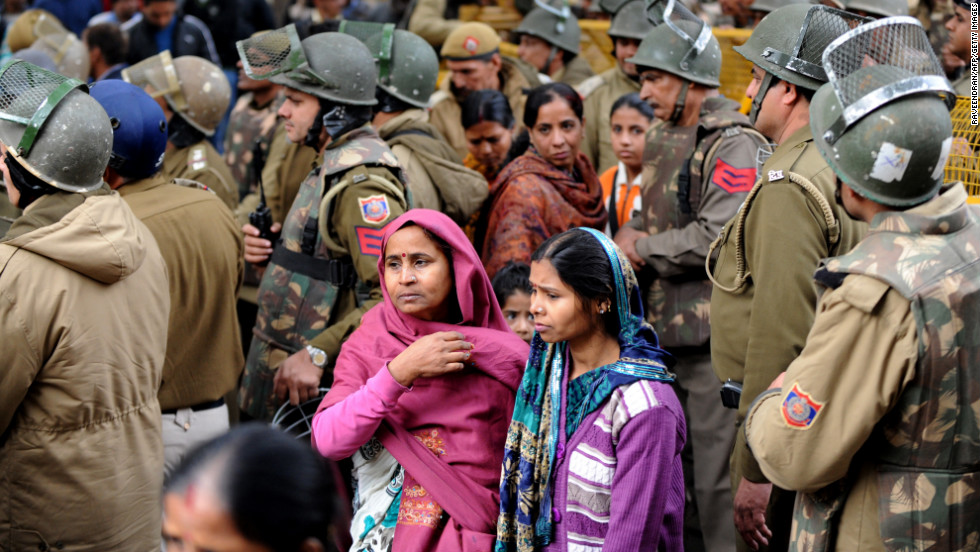 Indian protesters walk with police officials during a rally in New Delhi on Sunday, December 30, following the cremation of a gang-rape victim in the Indian capital. The 23-year-old student died Saturday and was cremated at a private ceremony, hours after her body was flown home from Singapore. She had been gang-raped and severely beaten on December 16, triggering an outpouring of grief and anger across India. 