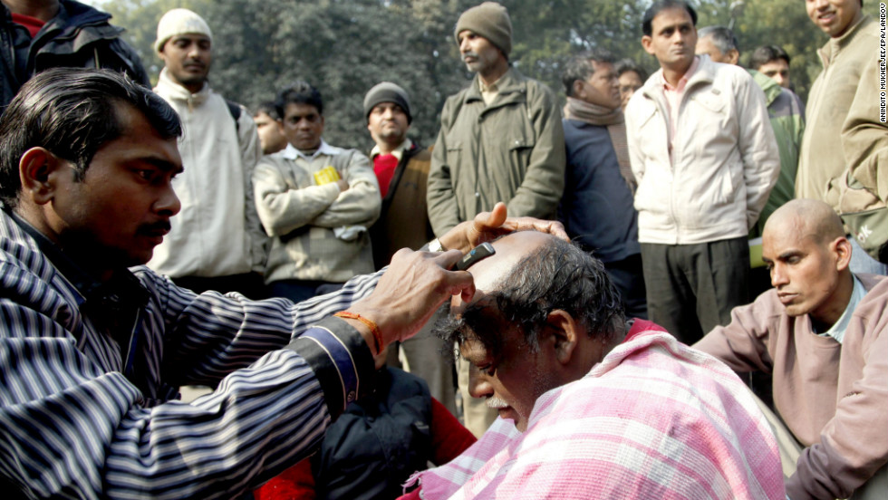 An Indian activist gets his head shaven in protest against the Dehli gang-rape in New Delhi on Friday, January 4. A gang of men is accused of repeatedly raping a 23-year-old student on a moving bus in New Delhi. Police formally charged the five suspects with rape, kidnapping and murder after the woman died.