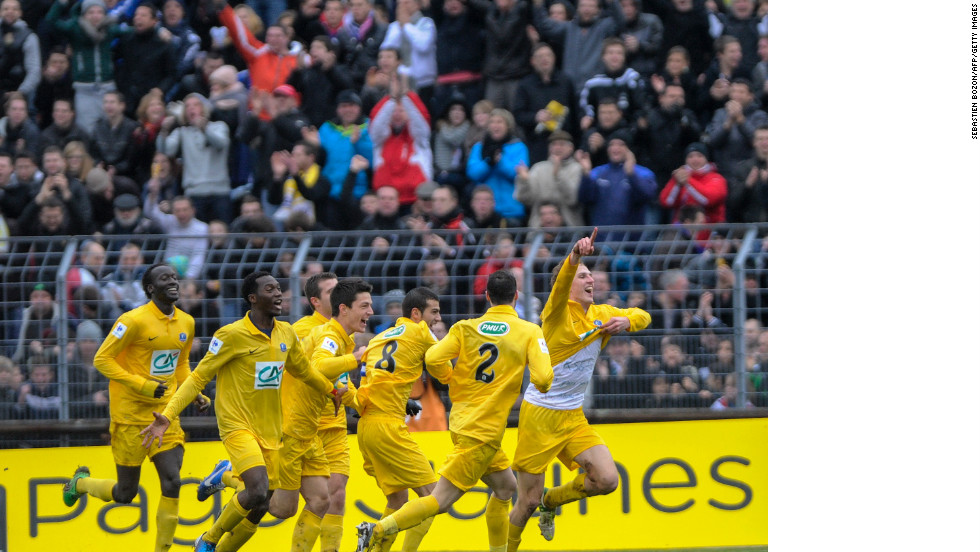 Epinal&#39;s French midfielder Tristan Boubaya races away to celebrate after netting against the giant of Lyon. Boubaya scored twice to give his side a 2-0 lead before Bafetembi Gomis  and Gueida Fofana brought the visitor level.