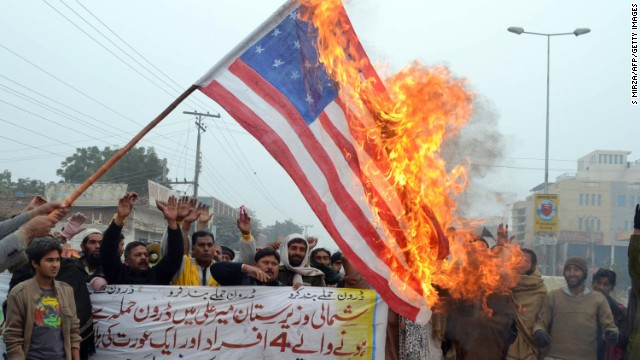 Pakistani demonstrators with a U.S. flag during protests in Multan January 3, 2013 against the drone attacks in tribal areas.