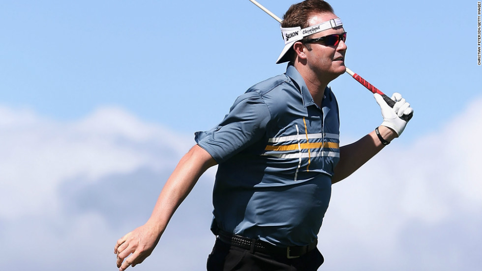 Charlie Beljan leans into the wind after taking a rehit on a tee shot on Sunday, when play was called off for the third day in a row in the PGA Tour&#39;s season-opening event. 