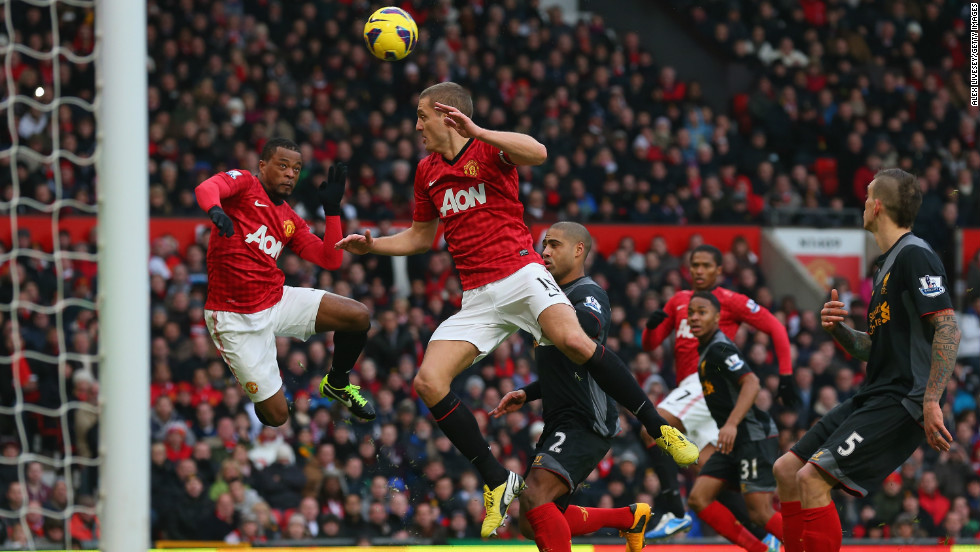 Nemanja Vidic was credited with Manchester United&#39;s winning goal against Liverpool after he inadvertently deflected a header by teammate Patrice Evra, left, past goalkeeper Pepe Reina.