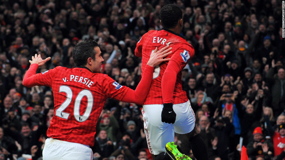 Evra, right, celebrates the goal with United&#39;s top scorer Robin van Persie at Old Trafford, as Alex Ferguson&#39;s team retained a seven-point lead in the English Premier League.  