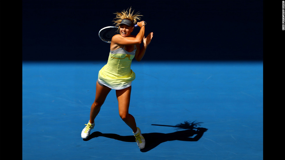 Russia&#39;s Maria Sharapova plays a backhand in her first-round match against Russia&#39;s Olga Puchkova on the first day of the Australian Open. 