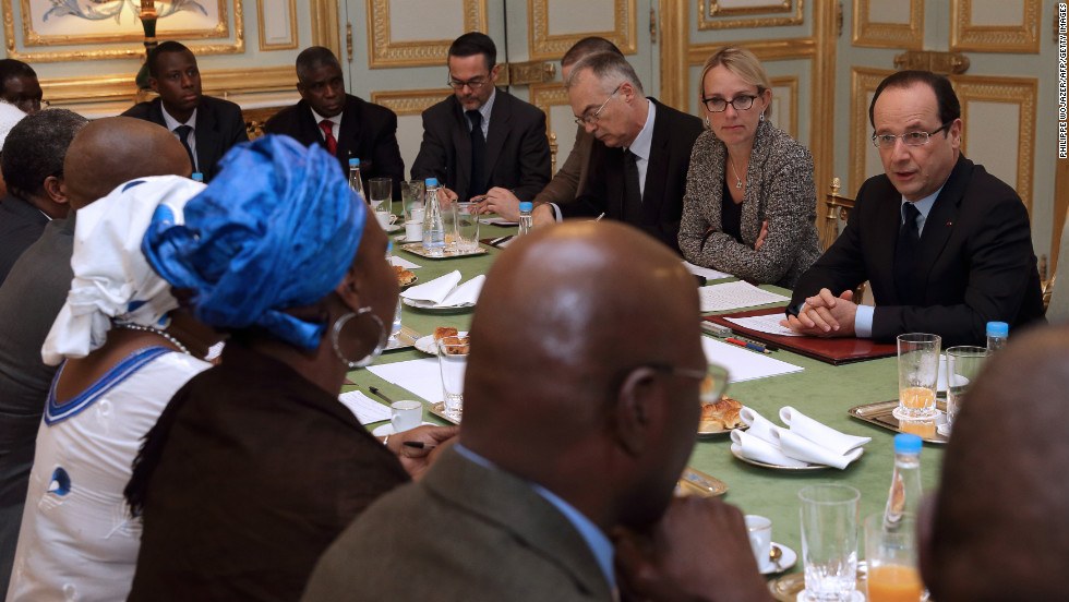 French President Francois Hollande, right, speaks with members of Malian associations in France during a meeting at the Elysee Palace in Paris on Sunday.